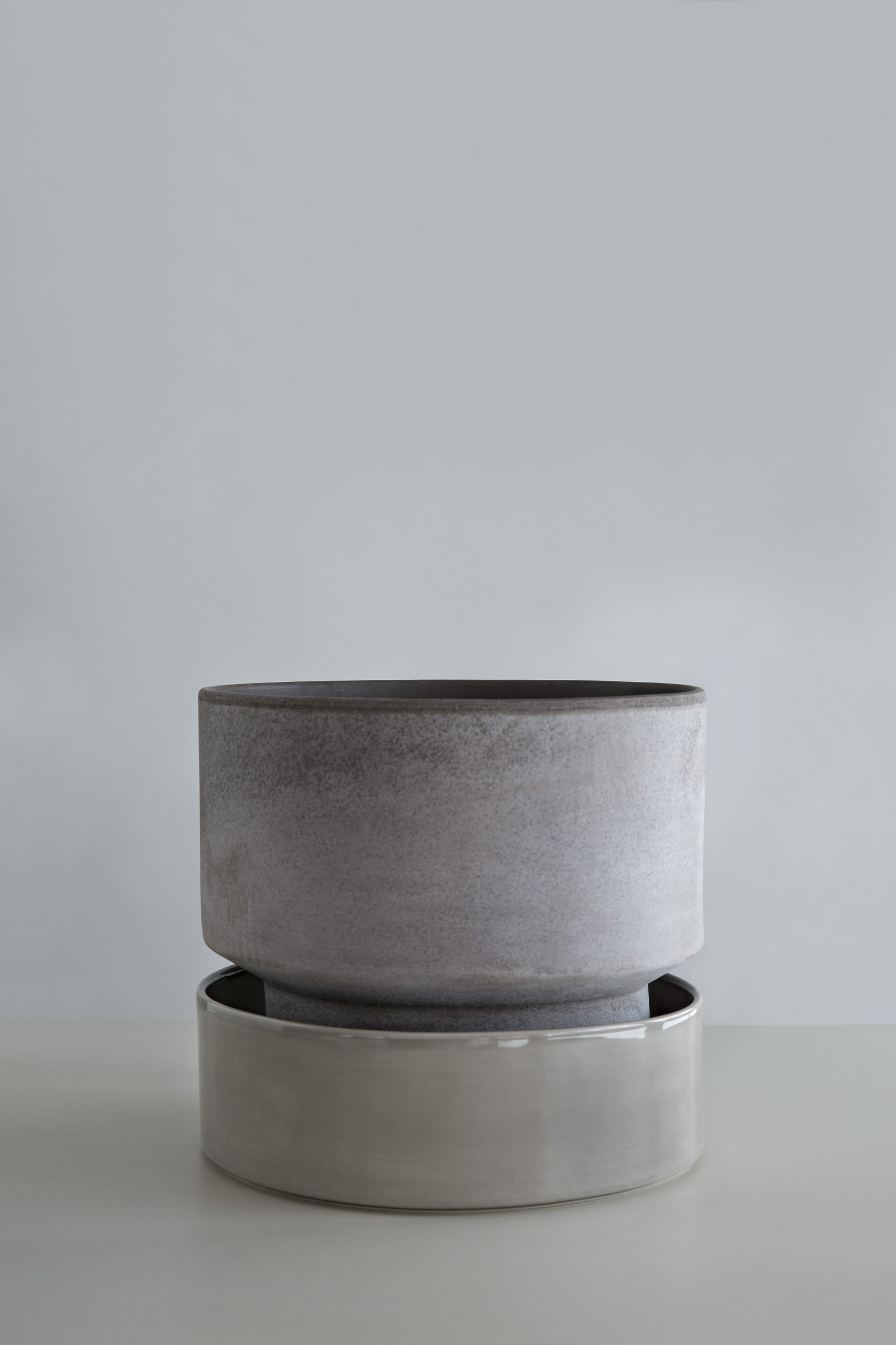 Raw grey pot with glazed pearl grey saucer.