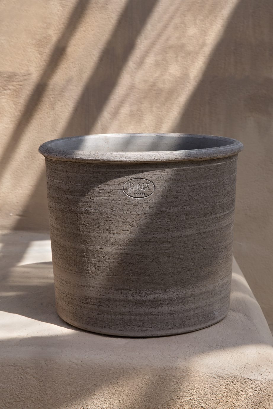 Raw grey empty cylindrical pot.