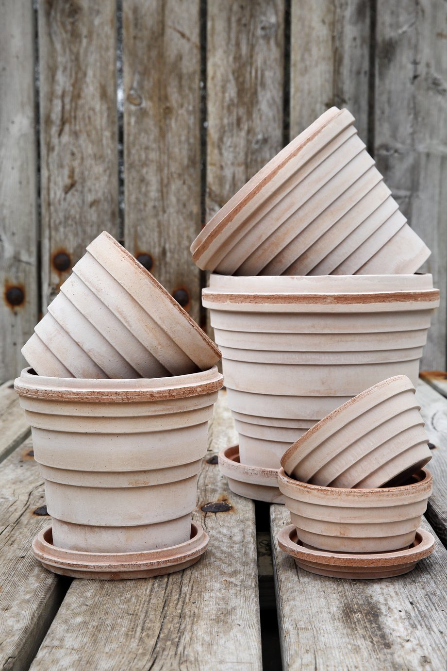 Collection of raw rose terracotta pots of layered rings