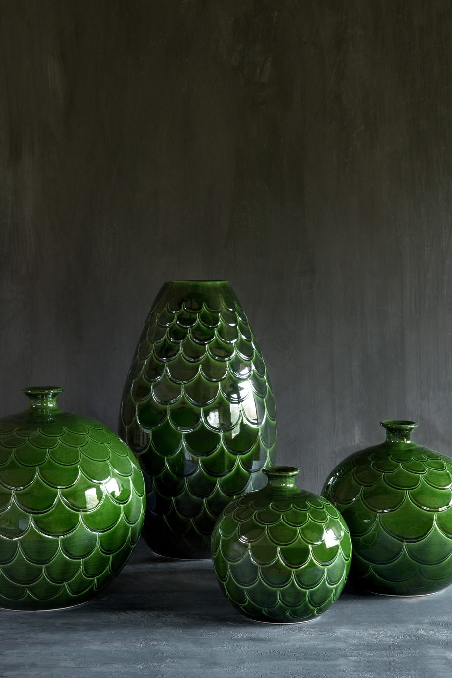 Collection of round- and cone-shaped vases glazed with emerald green.