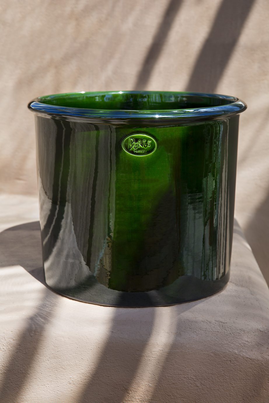 Cylindrical green glazed pot with Bergs signature stamp.