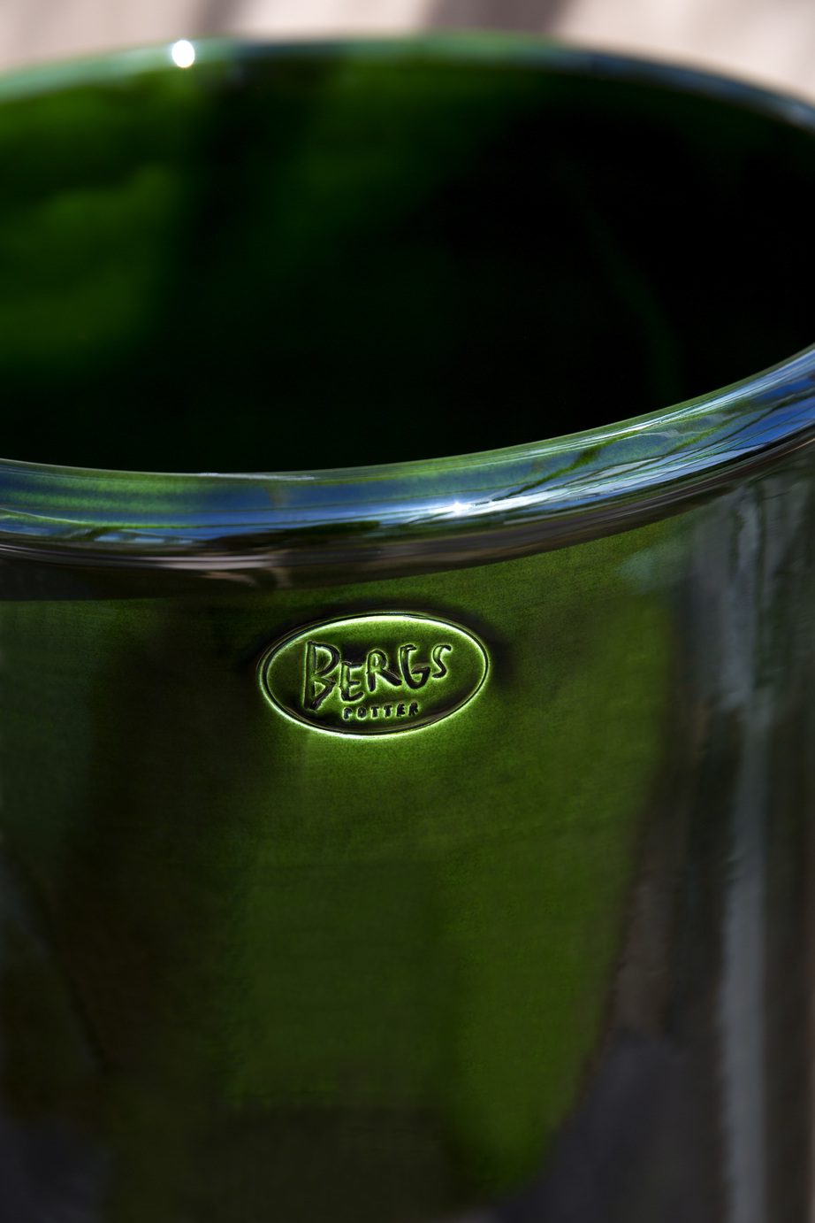 Glazed green pot with Berg's signature stamp.