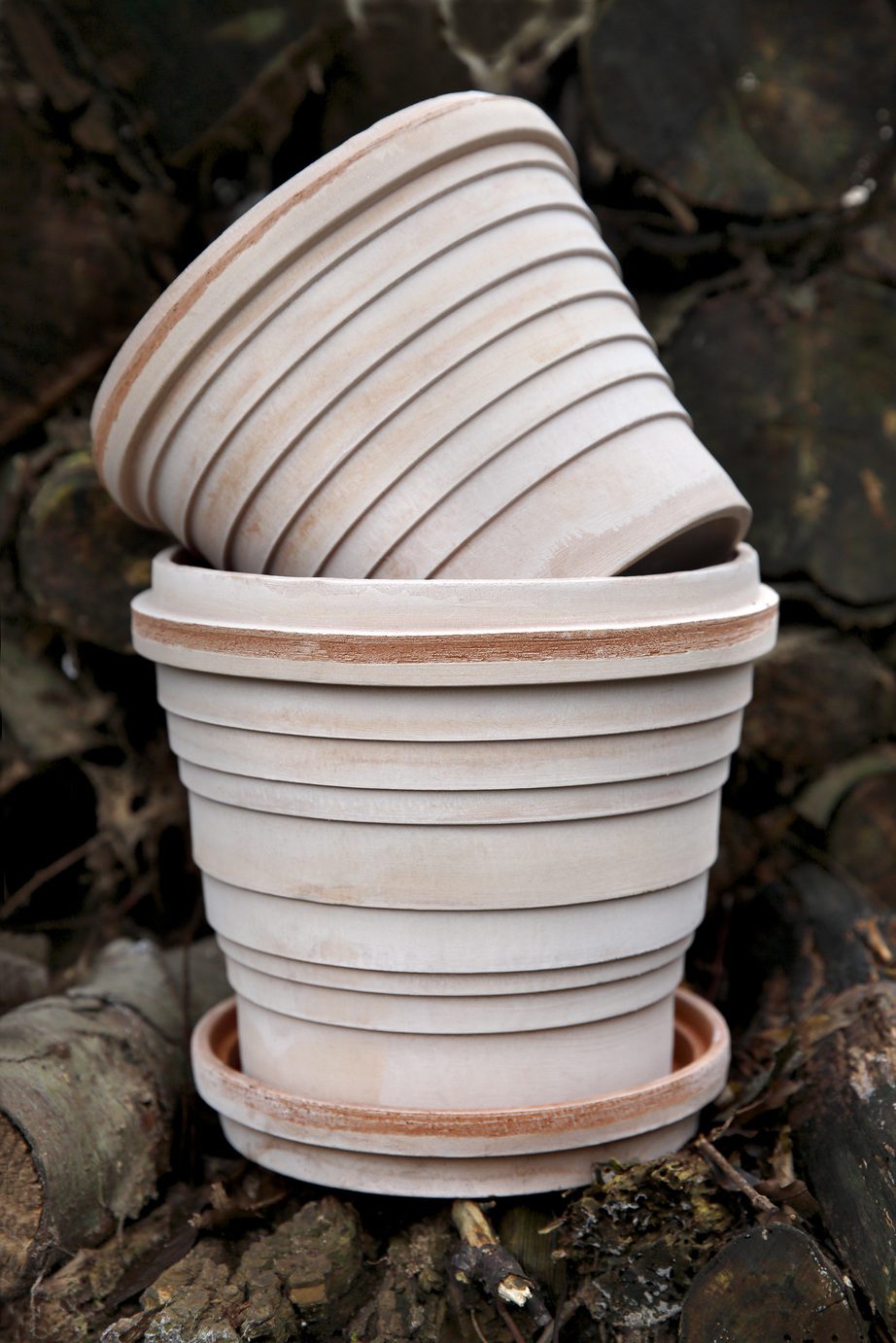 Two raw rose terracotta pots on top of each other.