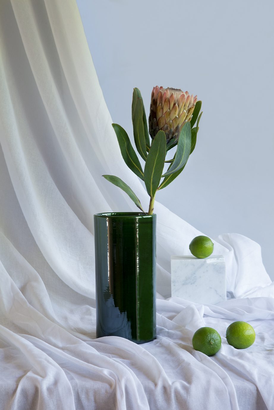 Green cylinder vase with flower