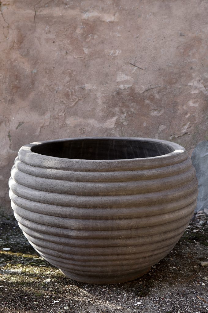 Raw grey outdoor pot with horizontal lines.